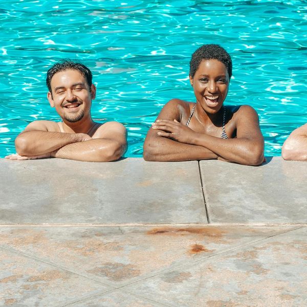 A diverse group of people smiling and looking relaxed after a wellness session.